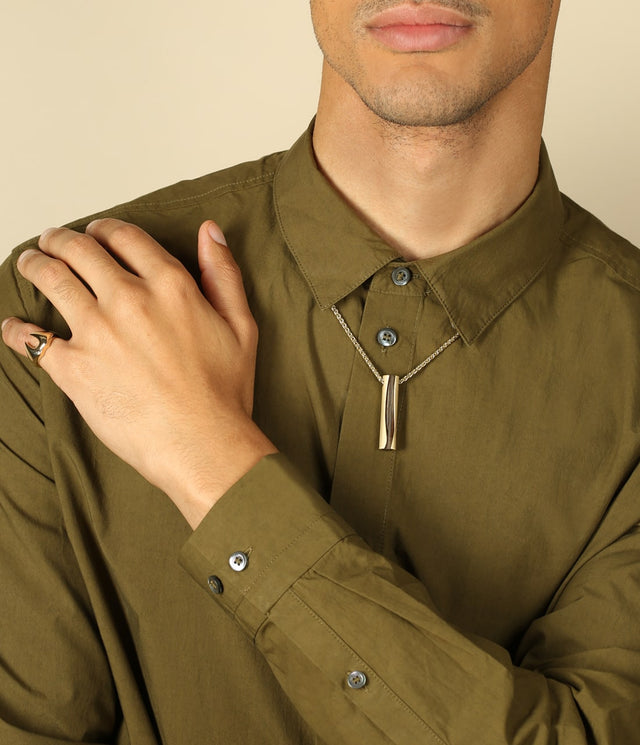 picture of a man wearing the London Oak wave pendant.